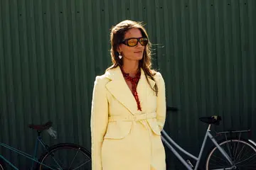 best valentine’s day jewellery gifts | woman in yellow blazer wearing heart shaped jewellery during fashion week