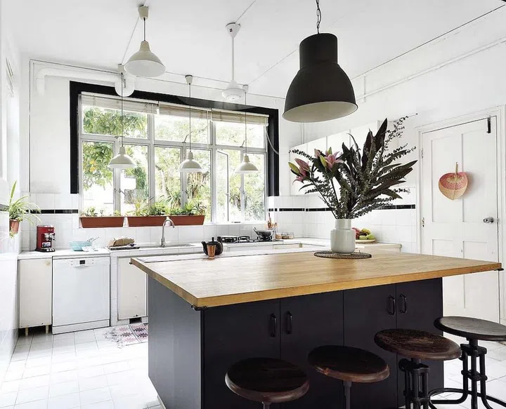 A large island with a wood counter connects the open kitchen with the living area. (Photo: Carli Teteris, courtesy of Grounded)
