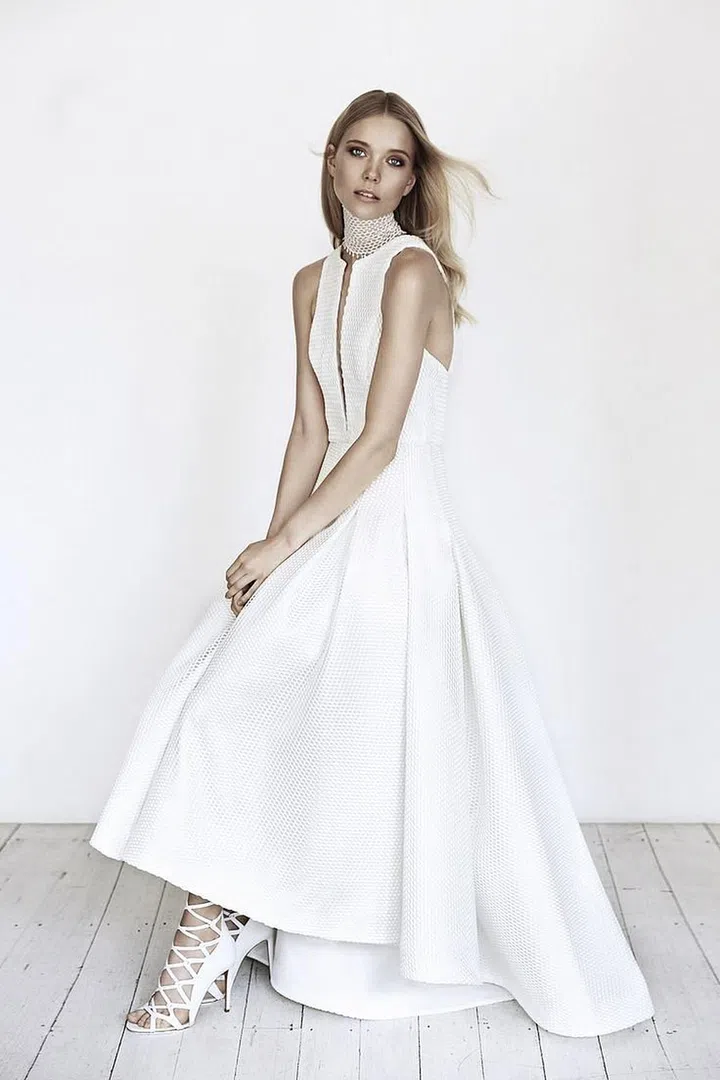 Australian designer Suzanne Harward has been creating bridal looks in Melbourne since 1975, but has recently landed on American soil with stockists in Los Angeles, San Francisco, Minneapolis and Dallas. Her collections offer something for every bride, and with a current point of view, she merges trend-driven concepts with a keen understanding of her diverse clientele. Her latest collections celebrated clean lines and a neo-Victorian vibe, offering a series of short, high-low, sheath, A-line, fit and flare and ball gown silhouettes with details like chic cut-outs, textural fabrications, 3D appliqués and micro-pleating that felt fresh, fashion-forward and sophisticated.