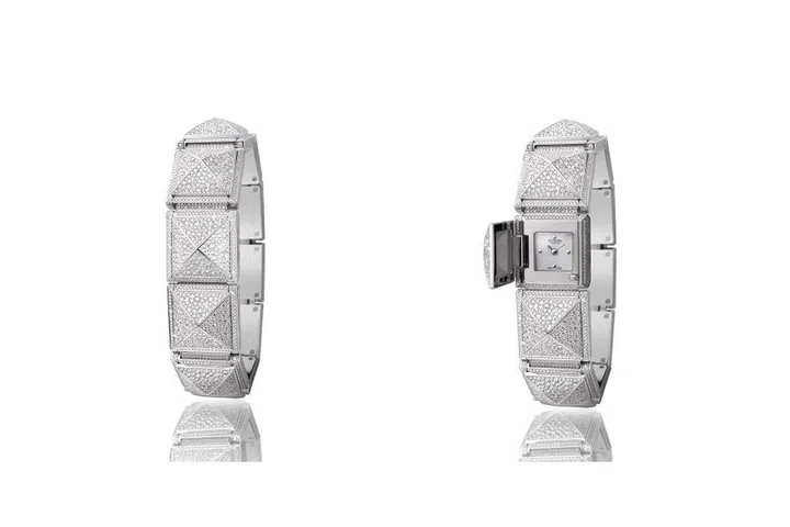 The classic studded Médor from Hermès gets reinterpreted in the most dazzling way, with 3,873 snow-set diamonds encircle the wrist in a series of ten pyramids, with the largest hiding a secret timepiece. Inspired by a dog collar, the Médor Secrète gives new meaning to the term pyramid power.
Price Upon Request. hermes.com