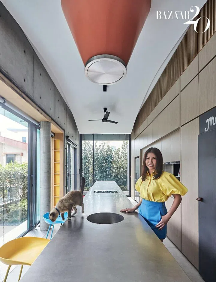 Chuah, in her Ellery top, ZARA shorts, and jewellery by Cartier and Tiffany & Co., standing next to the long stainless steel table in the wet kitchen.

Photo: Phyllicia Wang