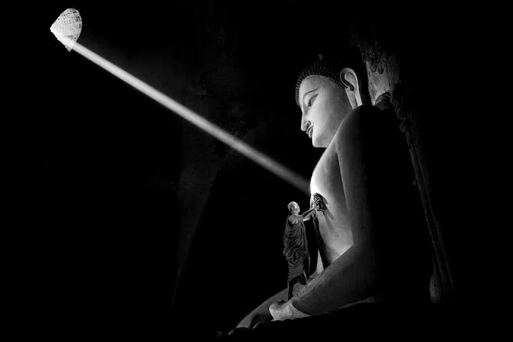 "The image was taken in one of Bagan's temples in Myanmar. It captures a very special moment when a sunbeam enters through a small window and hits the statue's heart while a monk is cleaning the statue at the same time." –Gunarto Gunawan