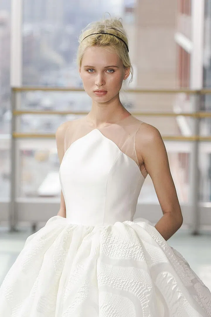 A thin black headband adds a sporty element to an otherwise sweet and feminine gown.