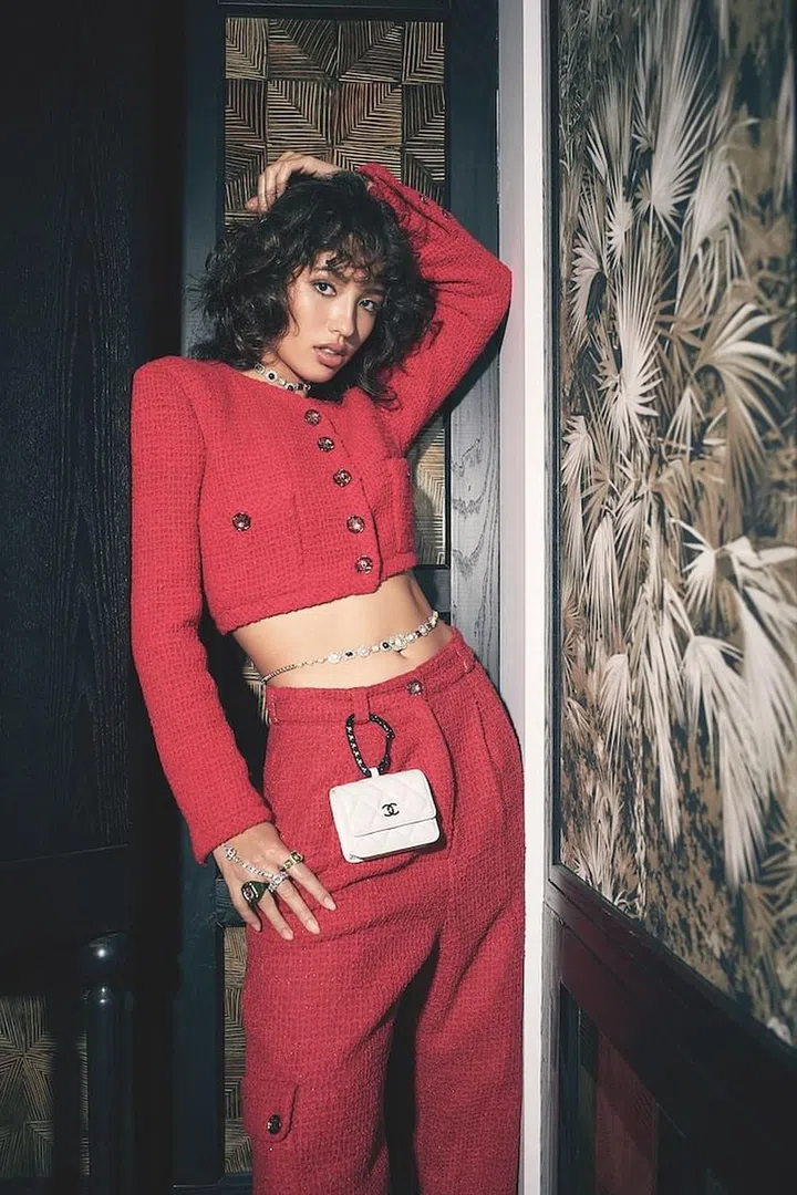 Cargo pants; matching jacket; necklace; belly chain; belt bag; bracelet with ring, all by Chanel. Rings, by Swarovski. (Photo: Veronica Tay)