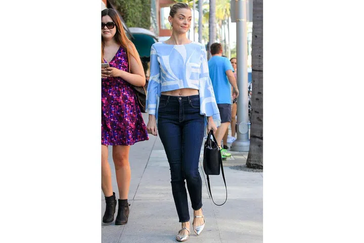 Jaime King shows off her toned post-baby body in midrise jeans with a cropped, bell sleeve blouse and metallic flats