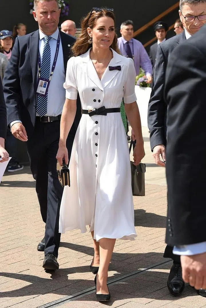 For day two of Wimbledon, the Duchess of Cambridge opted for a white button-front Suzannah midi-dress with a bow-belt and matching black cat-eye sunglasses. She completed her look with a chic basket bag, perfect for summer style.