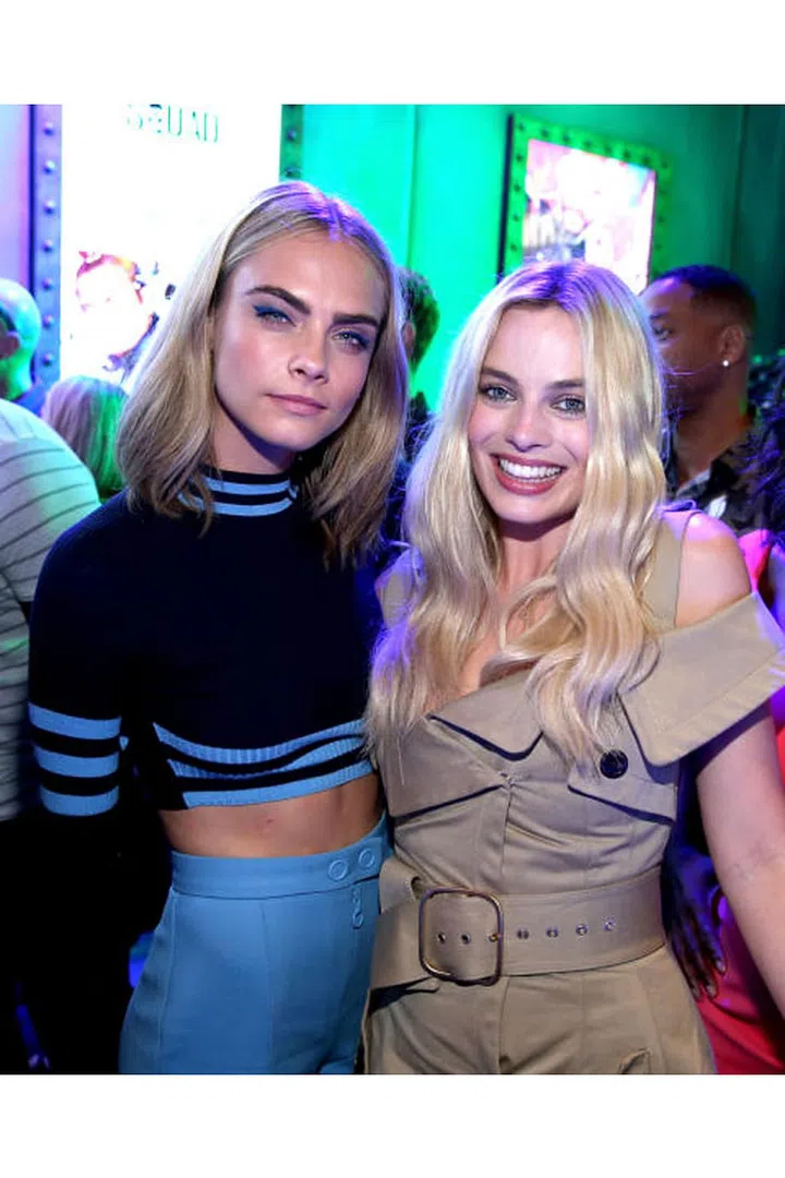 Cara Delevingne in a two-piece Versace set and Margot Robbie at San Diego Comic-Con 2016. Photo: Getty