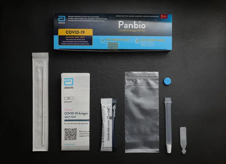 The Abbott PanBio sample kit had an instruction manual, a swab, a test device, a tiny bottle of solution, and a tube to hold the mixture. A resealable bag was also provided for waste disposal. ST PHOTO: ONG WEE JIN