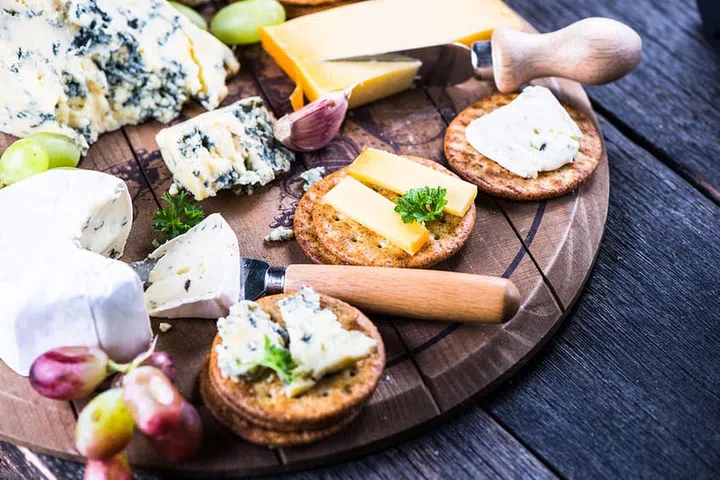 45728979 - oat crackers with cheese selection on wooden rustic board