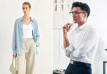 Caucasian woman wearing Meilleur Moment’s blue shirt, white top and beige linen pants and Asian man wearing white shirt and black pants from Determinant