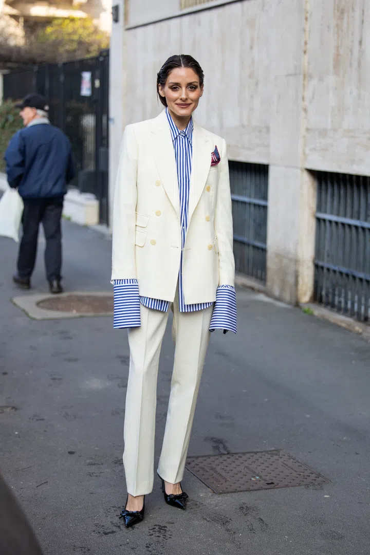 MILAN, ITALY - FEBRUARY 27: Olivia Palermo wears blue white striped blouse, creme white suit, pocket square outside Max Mara during the Milan Fashion Week Womenswear Fall/Winter 2025/2026 on February 27, 2025 in Milan, Italy. (Photo by Christian Vierig/Getty Images)