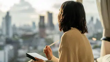 woman looking out window | local celeb quotes on being single