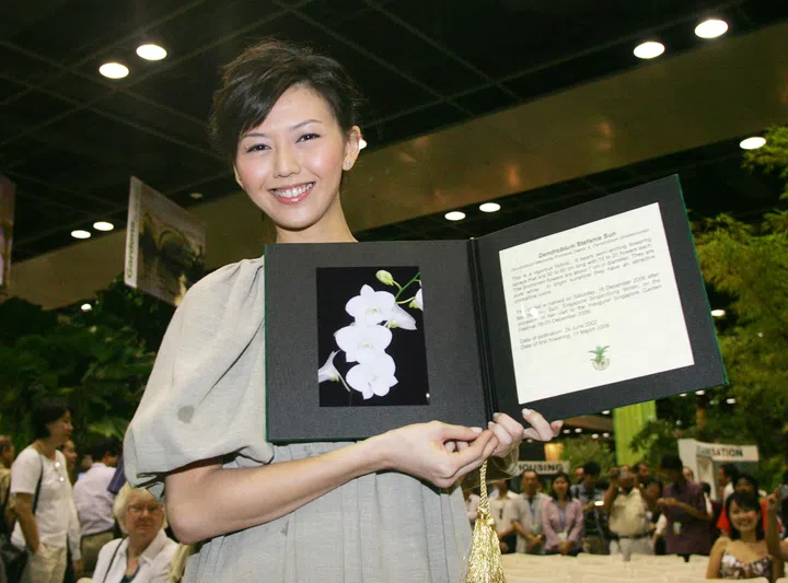 Singapore Garden Festival-Orchid Show prize presentation. Orchid Naming Session for Stefanie Sun. [Singer Stefanie Sun (above) yesterday became the first Singapore celebrity to have an orchid named after her. She chose a pure white orchid hybrid, which was named Dendrobium Stefanie Sun. ]