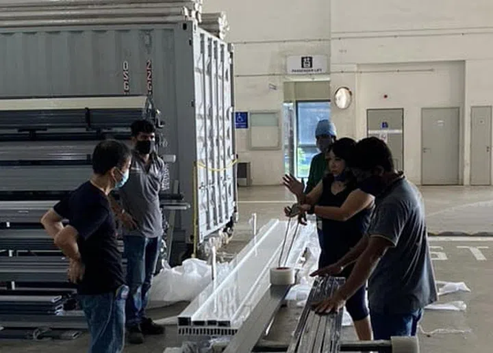 Quality control meeting with workshop workers