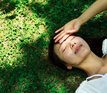 Young woman lying in the grass,healthy lifestyle - Why you might be low in vitamin D even in sunny Singapore