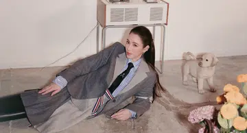 Arissa Cheo, founder of Romi Beauty, in a ponytail wearing a grey blazer, skirt and tie for the September Cover of Her World magazine