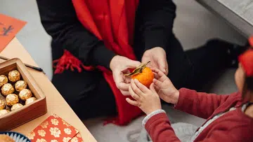exchanging oranges lunar new year celebration