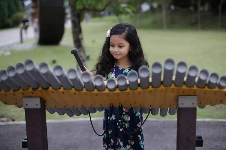 A child playing an instrument at Gardens by the Bay’s Active Garden on May 15, 2022. PHOTO: ST FILE