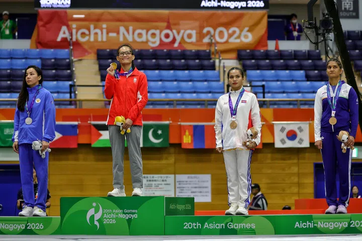 Gold medalist Tiffany Teo (second from left) of Singapore with (from left) silver medalist Khilola Sobirova of Uzbekistan, bronze medalists Cheng Dalin of Cambodia and Suchika Tariyal on the podium after the mixed martial arts women's traditional (60kg) final of the Aichi-Nagoya 2026 Asian Games at the Nagoya City Inae Sports Centre in Nagoya, Japan on Sept 22, 2026. ST PHOTO: KEVIN LIM pixag22