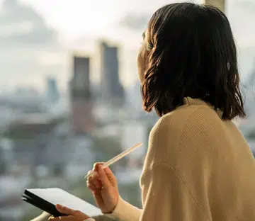 woman looking out window | local celeb quotes on being single