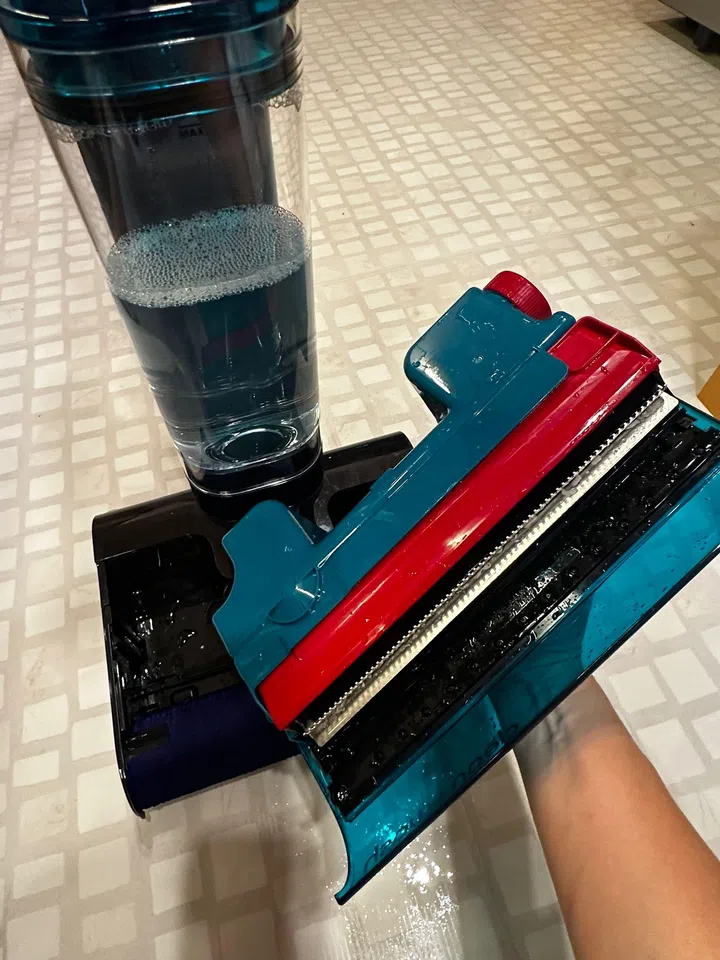 The new and improved dirty water tank of the Dyson Clean + Wash Hygiene