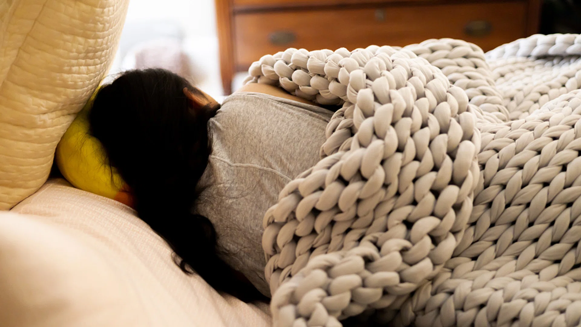 Weighted blanket on a bed designed to reduce anxiety and improve sleep quality