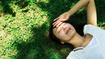 Young woman lying in the grass,healthy lifestyle - Why you might be low in vitamin D even in sunny Singapore
