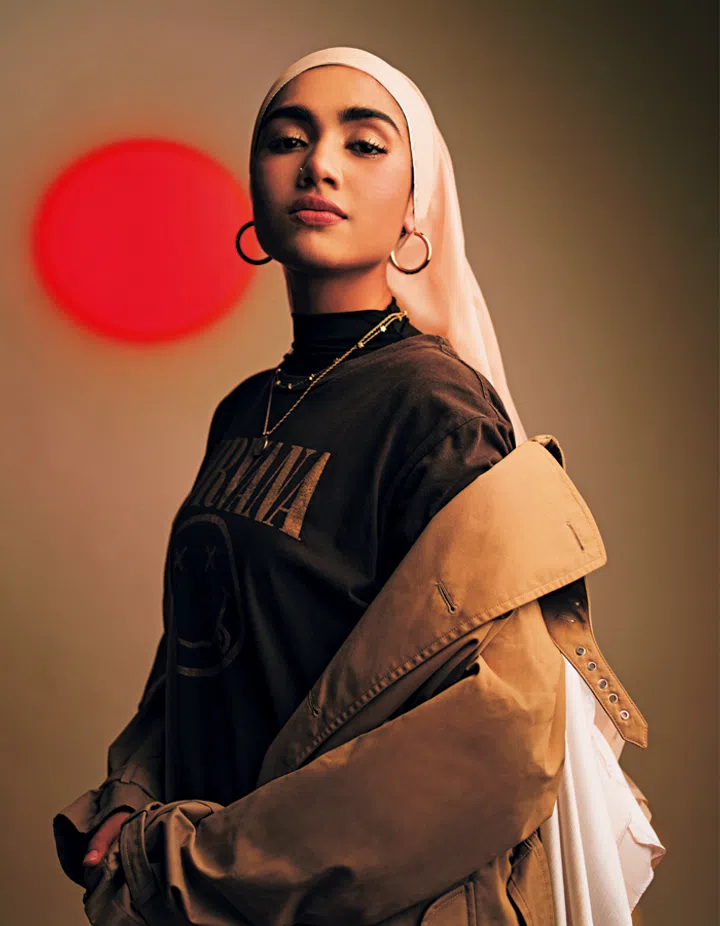 Cotton- blend twill trench coat, Ralph Lauren Collection. Vintage rock T-shirt, stylist’s own. Jewellery, Shazza’s own