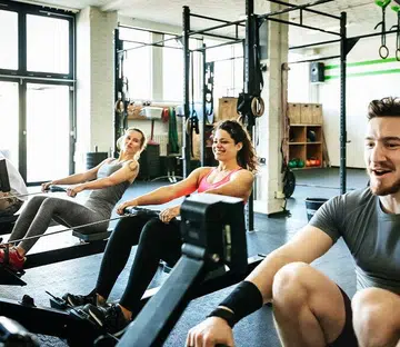 men and women rowing in the gym | gyms in Singapore that offer free trial pass