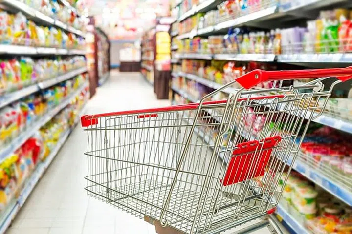 34987818 - supermarket interior, empty red shopping cart.