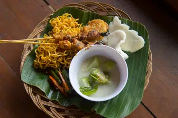 INDONESIA - 2019/05/16: Lunch with satay, soup, mi goreng, prawn crackers (krupuk udang) in the village of Candirejo in the countryside of central Java Island in Indonesia. (Photo by Wolfgang Kaehler/LightRocket via Getty Images)