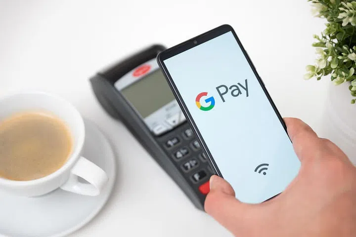 Wroclaw, Poland - NOV 06, 2019: Man holding smartphone with Google Pay logo. Google Pay is electronic wallet developed by Google.