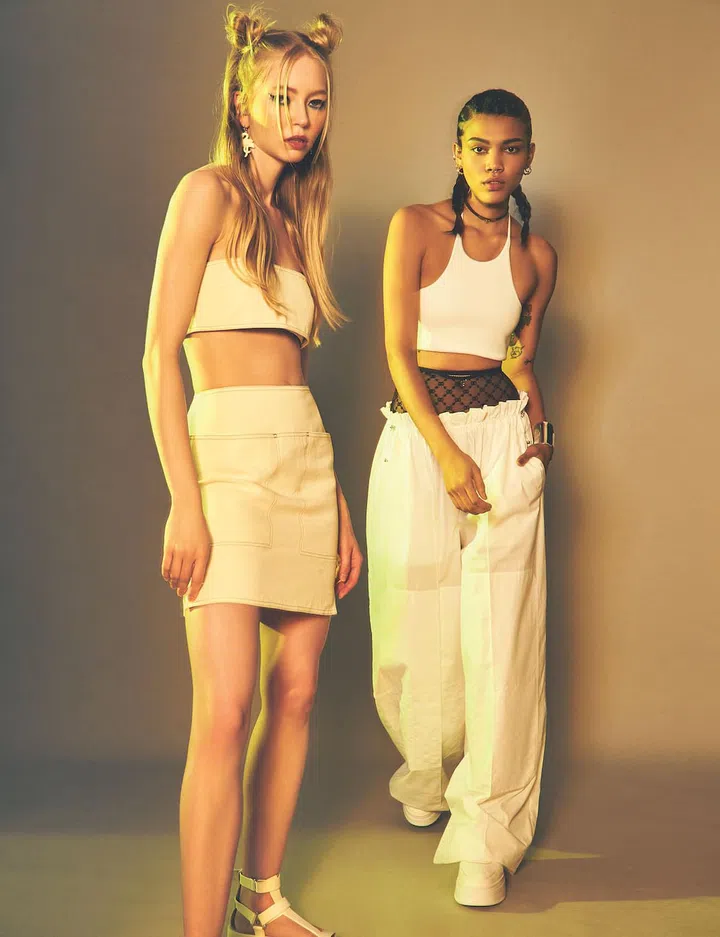 On Belinda: Cotton bandeau and matching miniskirt, Max Mara. Acrylic earrings, Coach. Scrappy leather platform sandals, Hermes

On Noelle: Ribbed cotton cropped top, oversized pants, leather choker with Kelly gold-plated clasp and silver oversized cuff, Hermes. Mesh high-waisted underwear, Gucci. Calfskin sneakers, Celine