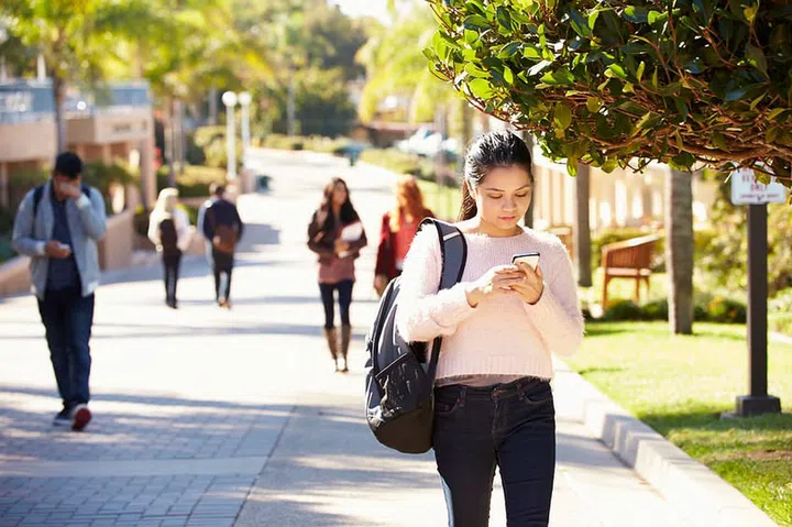 Students Walking Outdoors On University Campus