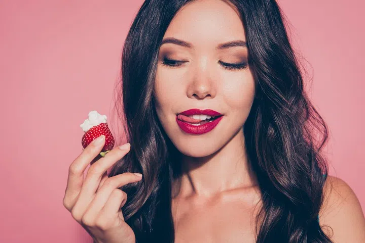 Close-up portrait of nice cute luxury lovely sweet attractive adorable wavy-haired lady licking red lips want wish looking at whipped cream dessert isolated over pink pastel background