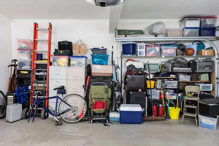 Garage storage shelves with vintage objects and equipment.