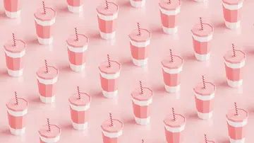 Seamless pattern of plastic cups containing strawberry milkshake filling the frame