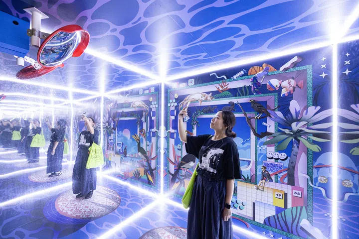 ST20250819_202503000510/shnight20/Brian Teo/Shawn Hoo/Overview of Two Sides of Our Island, an installation by LABSIXFIVE studio outside Raffles City shopping centre on Aug 19, 2025. Combining intricate illustrations with optical illusions, the work invites viewers into a layered experience that blends nostalgia with playful reinterpretations of familiar Singaporean motifs. The installation features three interactive photo spots—an infinity room with a “selfie” mirror, a vibrant illustrated backdrop, and a tranquil seating area surrounded by floating islands—enhanced by a custom scent for a fully multi-sensory encounter. ST PHOTO: BRIAN TEO 