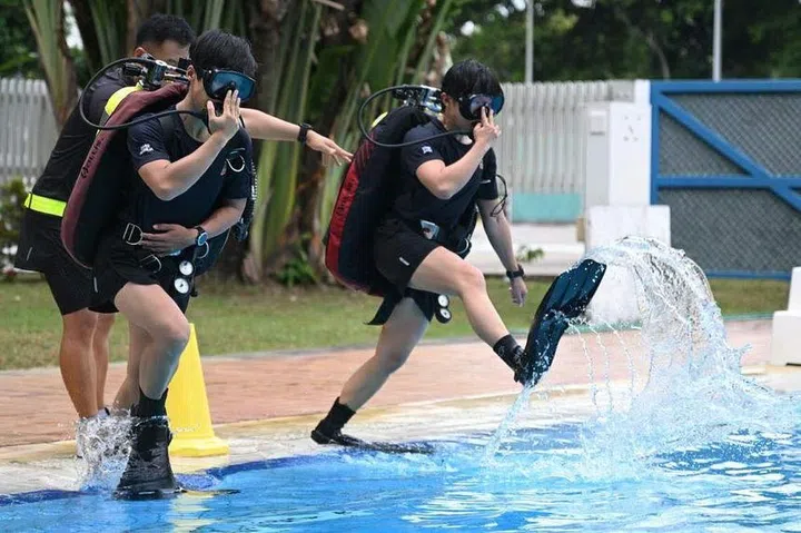 Cpt Tan (left) and Cpt Ng preparing to dive at Sembawang Camp on April 8. ST PHOTO: AZMI ATHNI