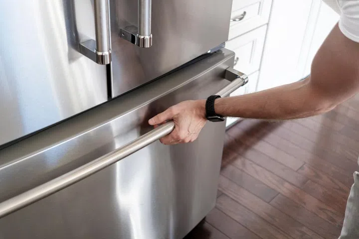 Close-up of unrecognizable man opening freezer door