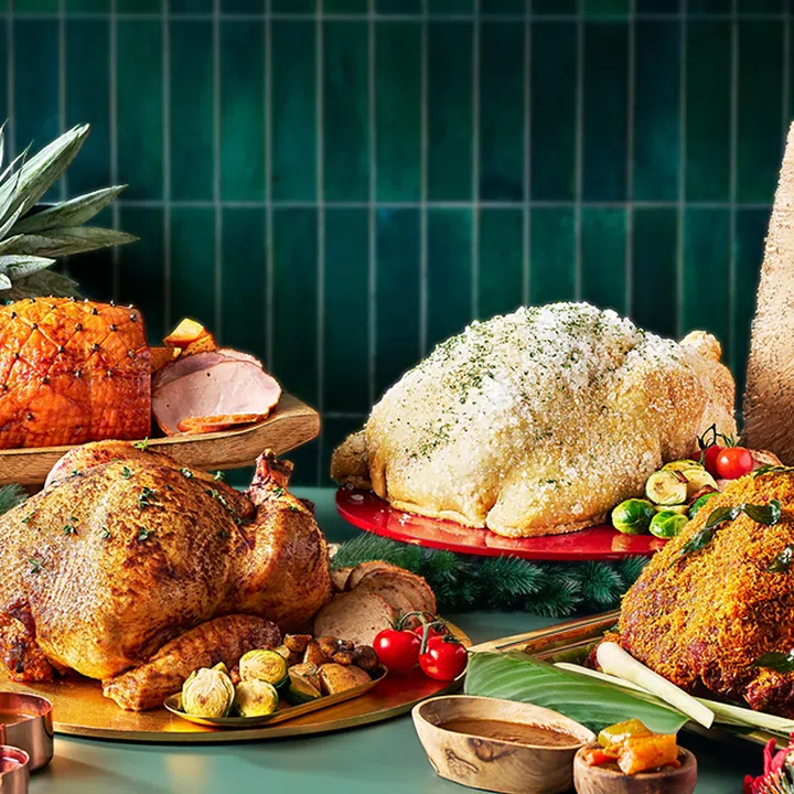 One Farrer Hotel’s (foreground, clockwise from left) traditional roast turkey, pineapple-glazed gammon ham, salt-crusted turkey and satay-marinade turkey.