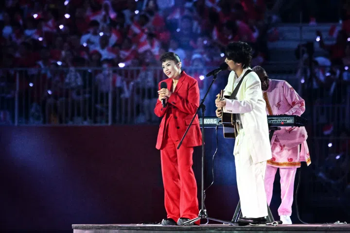 Kit Chan and Charlie Lim performing NDP 2025 theme song, ‘Here We Are’ during Act One: Our People, Our Diversity of the show segment during National Day Parade (NDP) 2025 Preview 1 at Padang on July 26, 2025. (ST PHOTO: CHONG JUN LIANG)