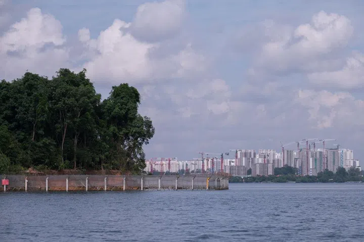 The border fence around Pulau Ubin, one of the small islands surrounding Singapore's main island and part of its north eastern border with Malaysia is seen with the public housing estates of the Singapore mainland in the distance on Saturday, 4 September 2021. (Photo by Joseph Nair/NurPhoto via Getty Images)