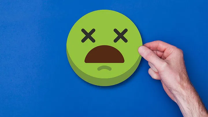 Male hand holding a emoji emoticon smiley head icon