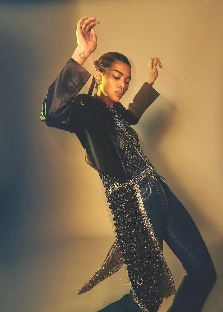 Embellished top with attached train, leather cropped jacket, and denim jeans, Louis Vuitton