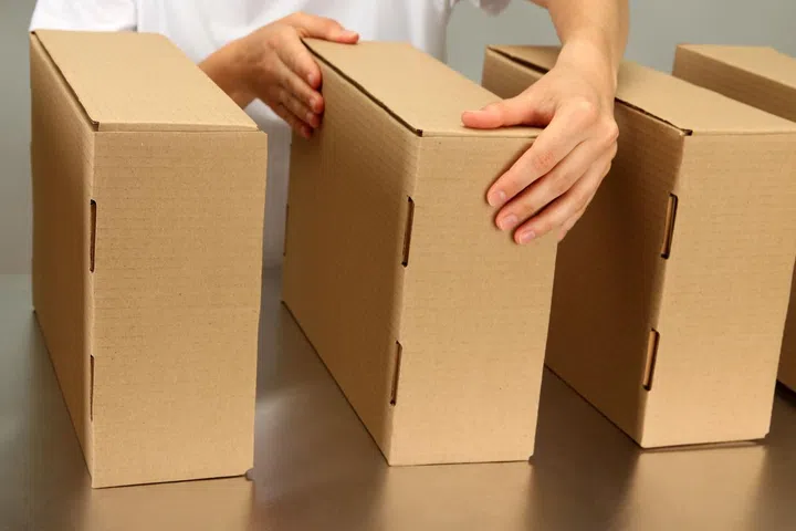 20811423 - worker working with boxes at conveyor belt, on grey background