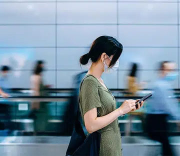 woman using phone in the middle of walkway