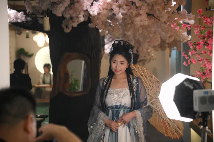 A patron dresses up in Hanfu, a traditional Chinese dress, during a photo shoot at Yagyo Haven, a chinese spa that opened in January, on March 6, 2026.
