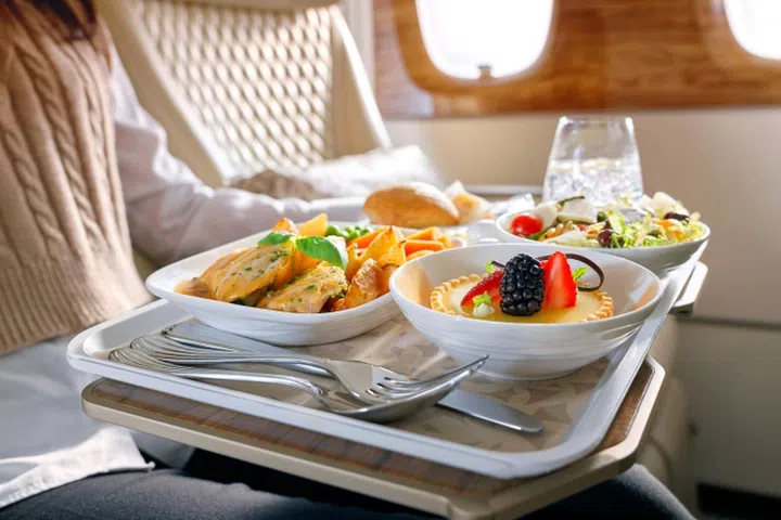 Enjoy multi-course meals as you catch up with the latest movies during your flight. Credit: Emirates