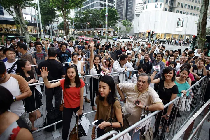 SINGAPORE - OCTOBER 15: People wait in line to get the Sugarpova candy packets autographed by Maria Sharapova at Robinsons The Heeren on October 15, 2014 in Singapore. The world number two, Maria Sharapova was in Singapore to launch her Sugarpova, line of candies ahead of her participation in Women's Tennis Association (WTA) Finals. (Photo by Suhaimi Abdullah/Getty Images)